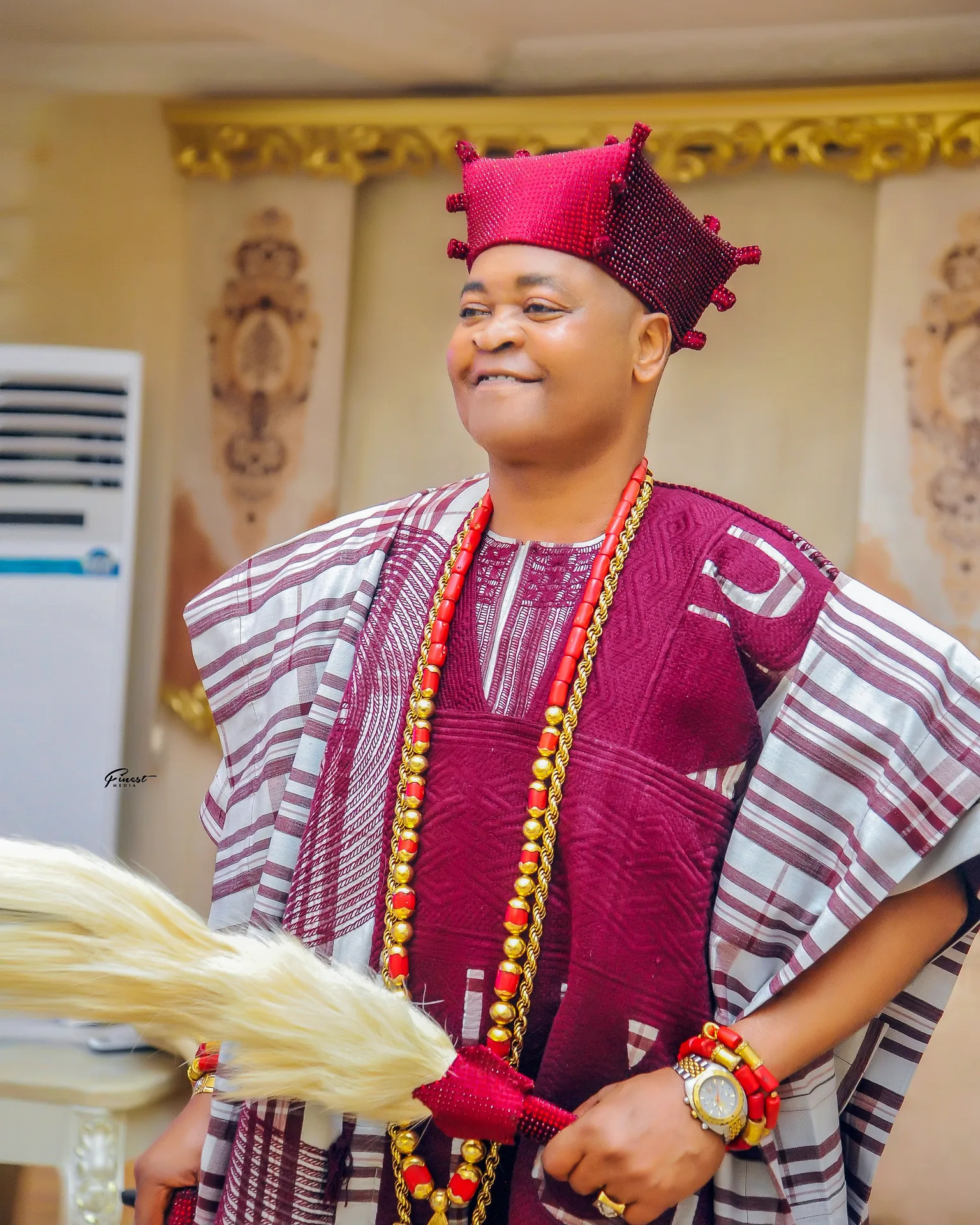 His Royal Majesty Oba Abdulfatai Akorede Akamo in traditional brown and maroon royal attire