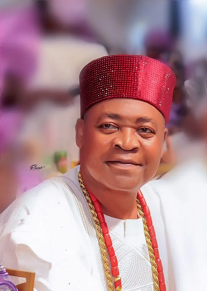 His Royal Majesty in vibrant purple robes and crown during royal ceremony